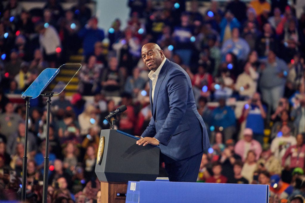 Basketball icon Magic Johnson addresses a crowd of Kamala Harris supporters at a rally for the Democratic presidential candidate.