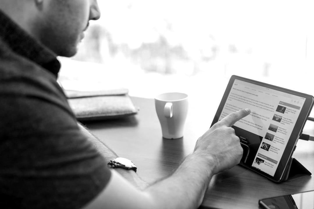 man holding tablet computer man holding tablet computer