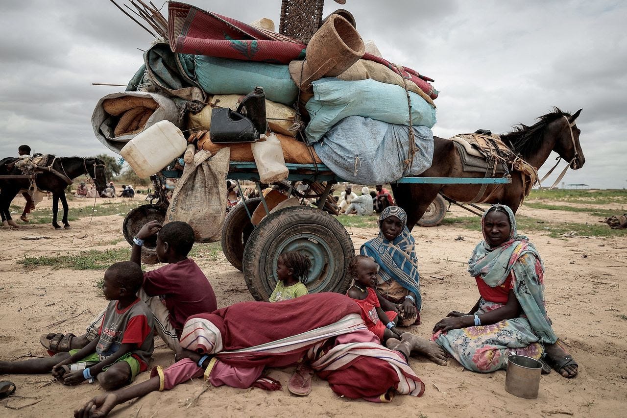 Members of a Sudanese family who fled the conflict in the Darfur region sit beside their belongings while waiting to be registered by the United Nations refugee agency after crossing into Chad in July. (Zohra Bensemra/Reuters)