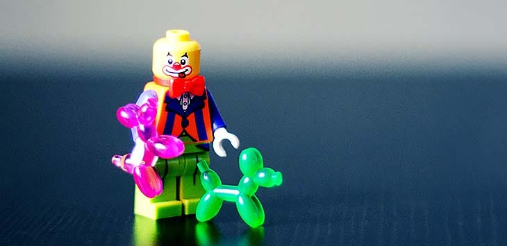 Photo of a Lego clown figure with two balloon dogs.
