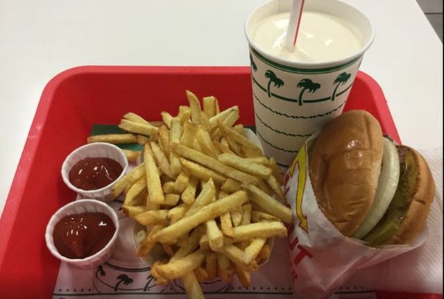 A tray of french fries and a drink

Description automatically generated