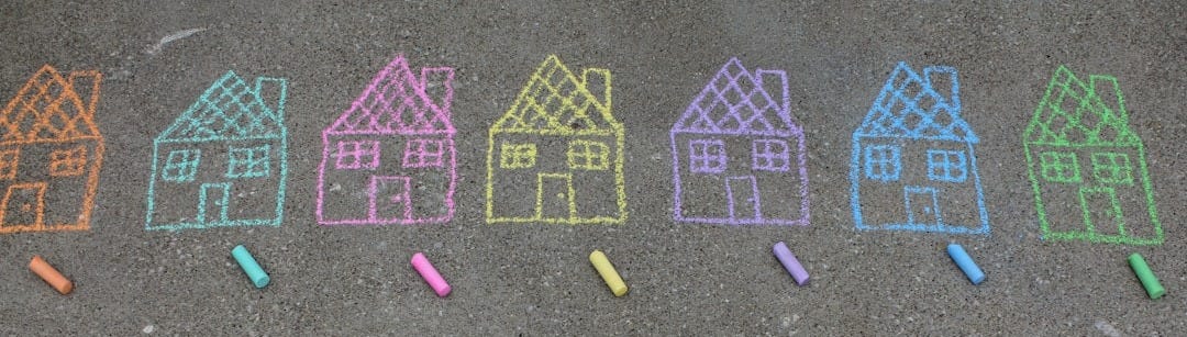 assorted-color house illustration on gray concrete surface