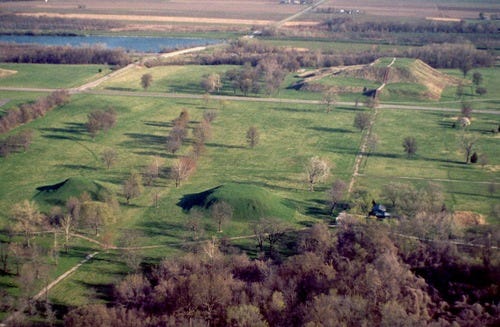 Cahokia Mounds - Monk's Mound at the Background with smaller mounds at the foreground Cahokia Mounds - Monk's Mound at the Background with smaller mounds at the foreground