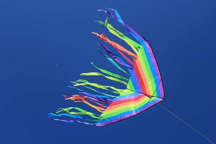 A child’s kite with the image of a rainbow. A child’s kite with the image of a rainbow.