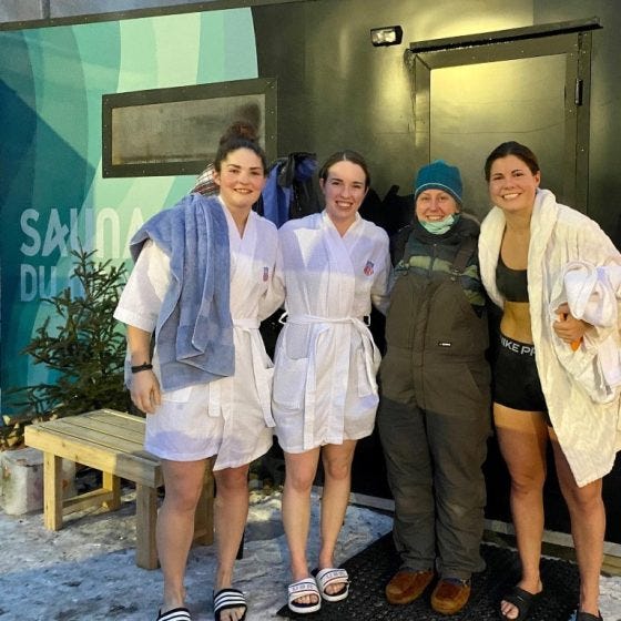Megan (in hat and bibs) with members of the US Olympic Hockey team when they stopped by Sauna village at the Great Northern Festival.