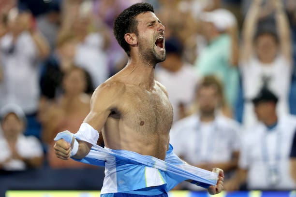 Novak Djokovic of Serbia tears his shirt off after defeating Carlos Alcaraz of Spain during the final of the Western & Southern Open at Lindner...