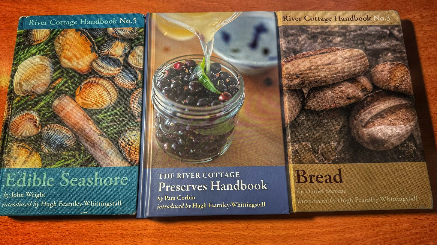 The three River Cottage Handbooks, arranged side-by-side on a tabletop