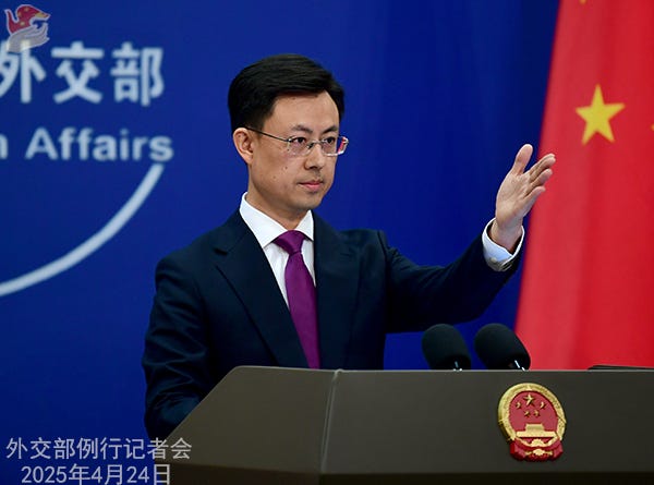 Chinese Ministry of Foreign Affairs spokesperson Guo Jiakun is pictured with his hand outstretched as if calling on a reporter in front of a Chinese flag and behind a lectern. Text on the bottom right of the image says 外交部例行记者会 2025年4月24日