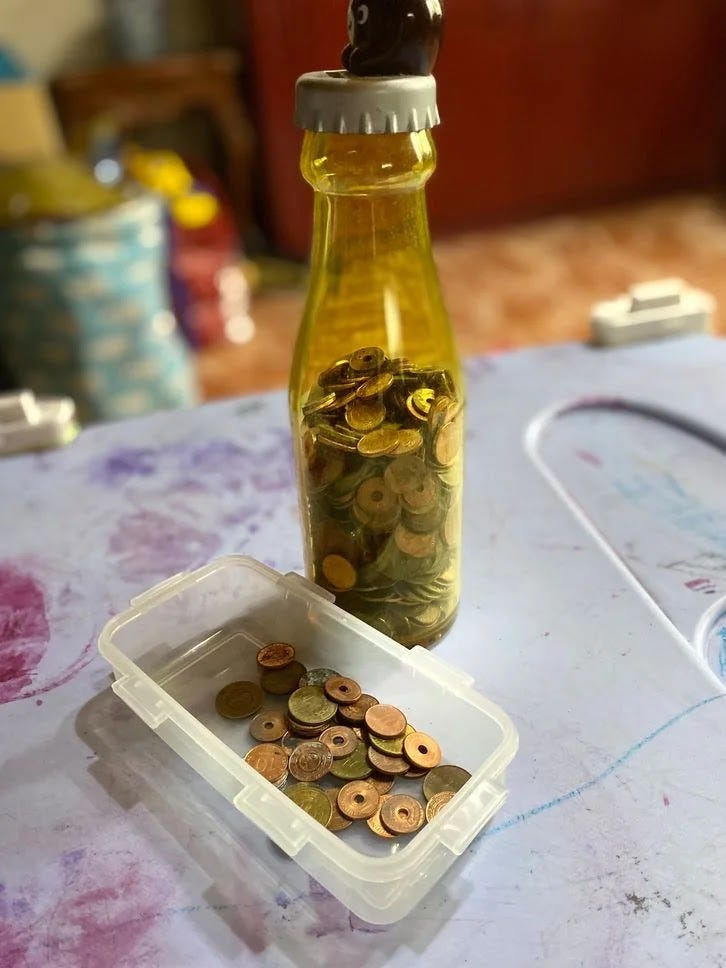 Dropping coins in a piggy bank to improve hand and eye coordination