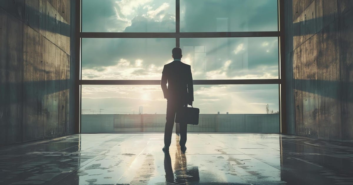 Businessman standing in the sunset