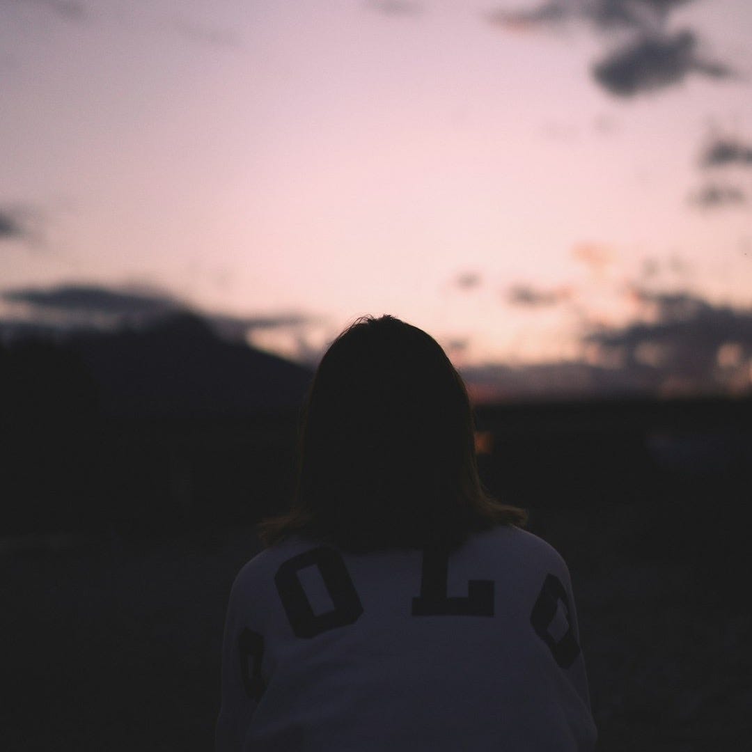 woman in white and black shirt standing during daytime
