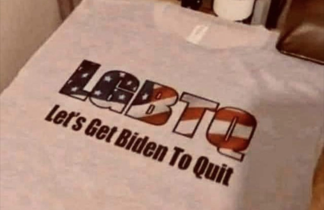 A t-shirt says, L G B T Q, Let's Get Biden To Quit.