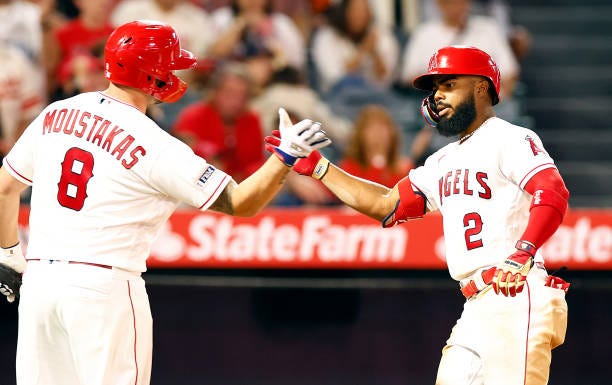 Luis Rengifo of the Los Angeles Angels celebrates a two-run home run with Mike Moustakas against the Baltimore Orioles in the third inning at Angel...