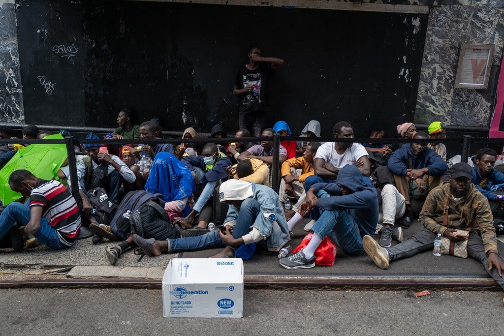 Hundreds of newly arrived migrants waiting outside Manhattan's Roosevelt Hotel for assistance in July 2023.