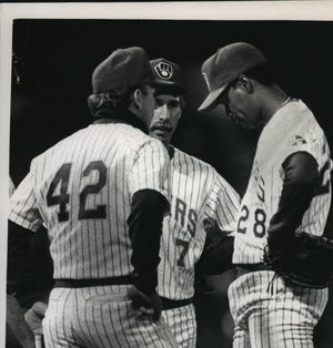 Odell Jones (right) is taken out of a game in the fifth inning by manager Tom Trebelhorn in 1988 against California, one start after he nearly delivered a remarkable no-hitter in a spot start for the Brewers.