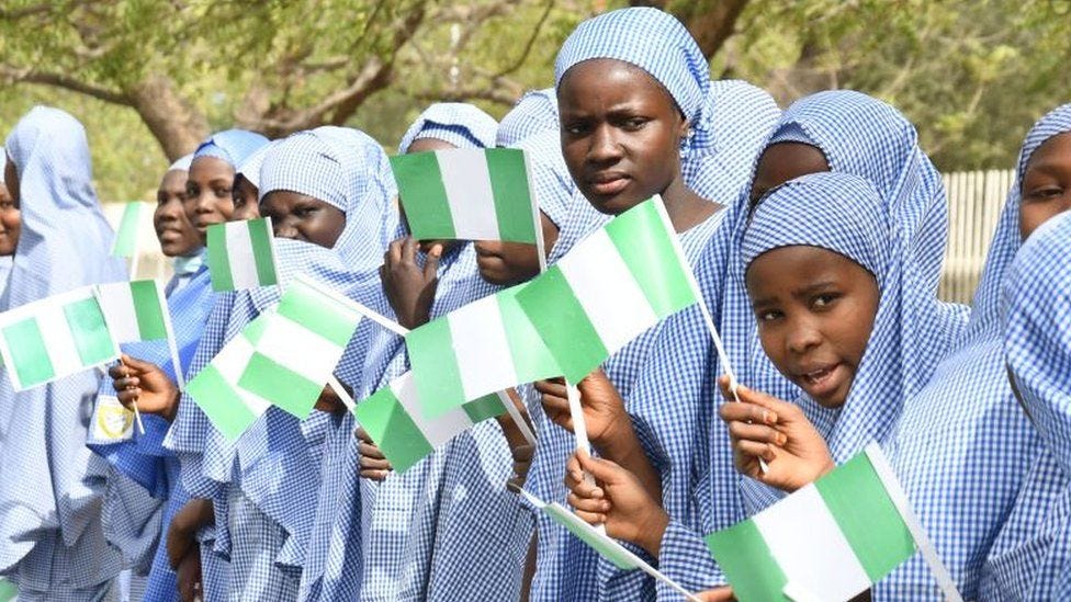Students hold Nigerian flags