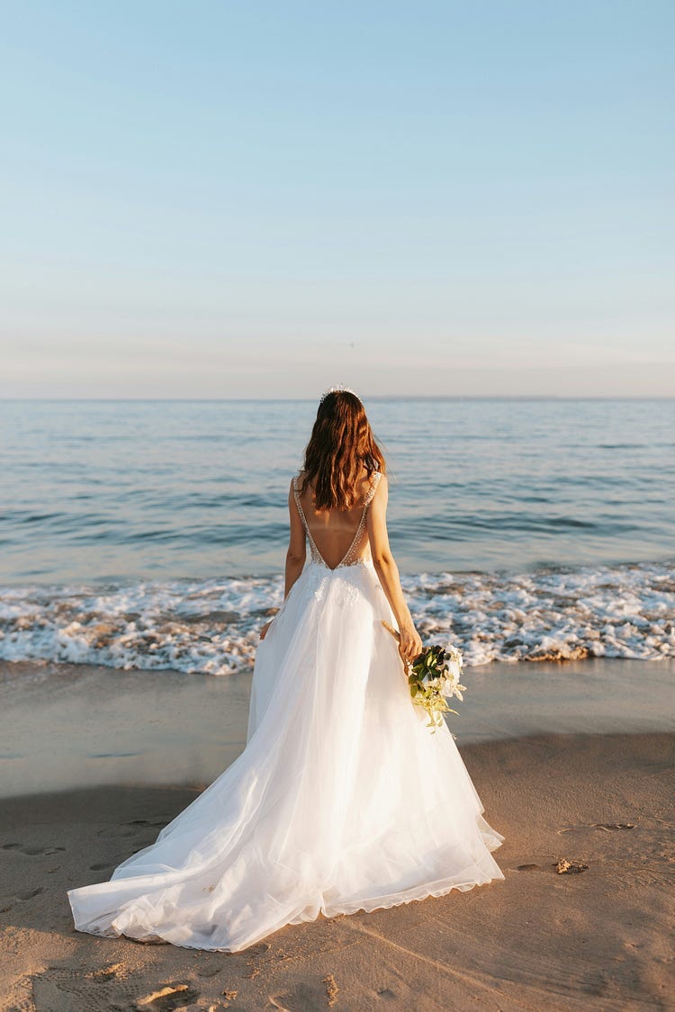 Bride looking out at sea.