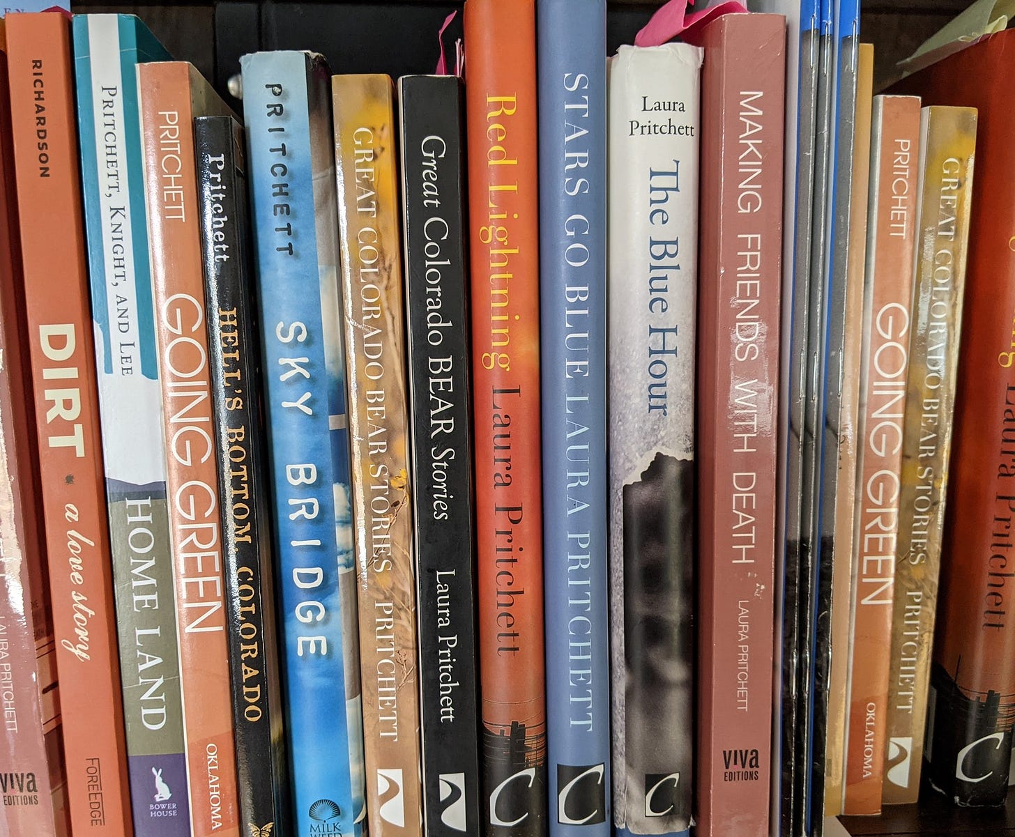 a collection of laura pritchett's books on a shelf