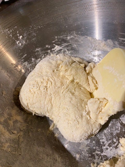 biscuit dough in a stainless steel bowl