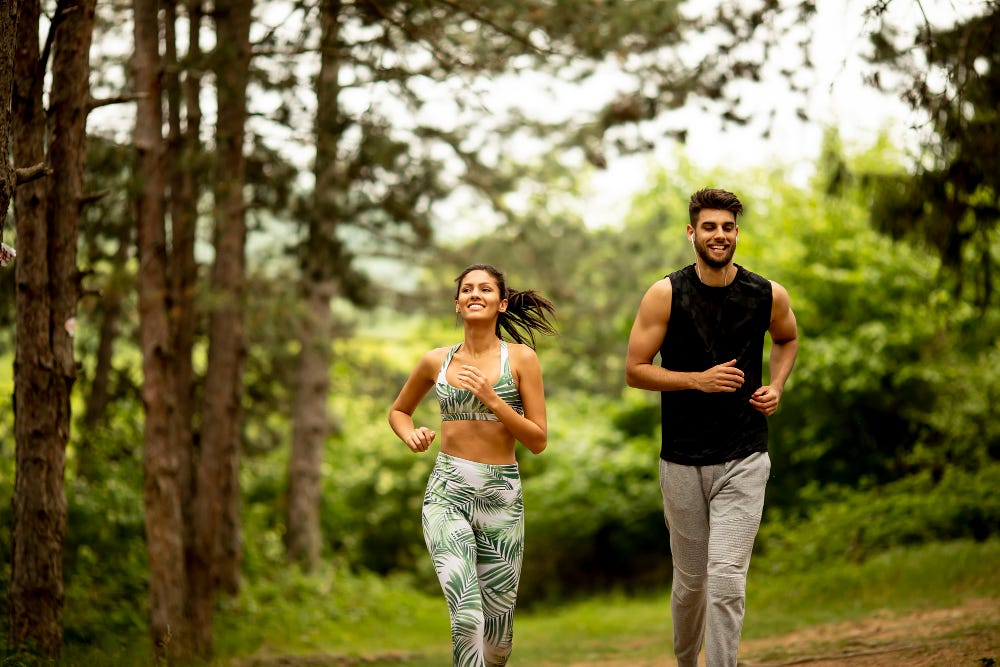 Young healthy couple running in a morning.