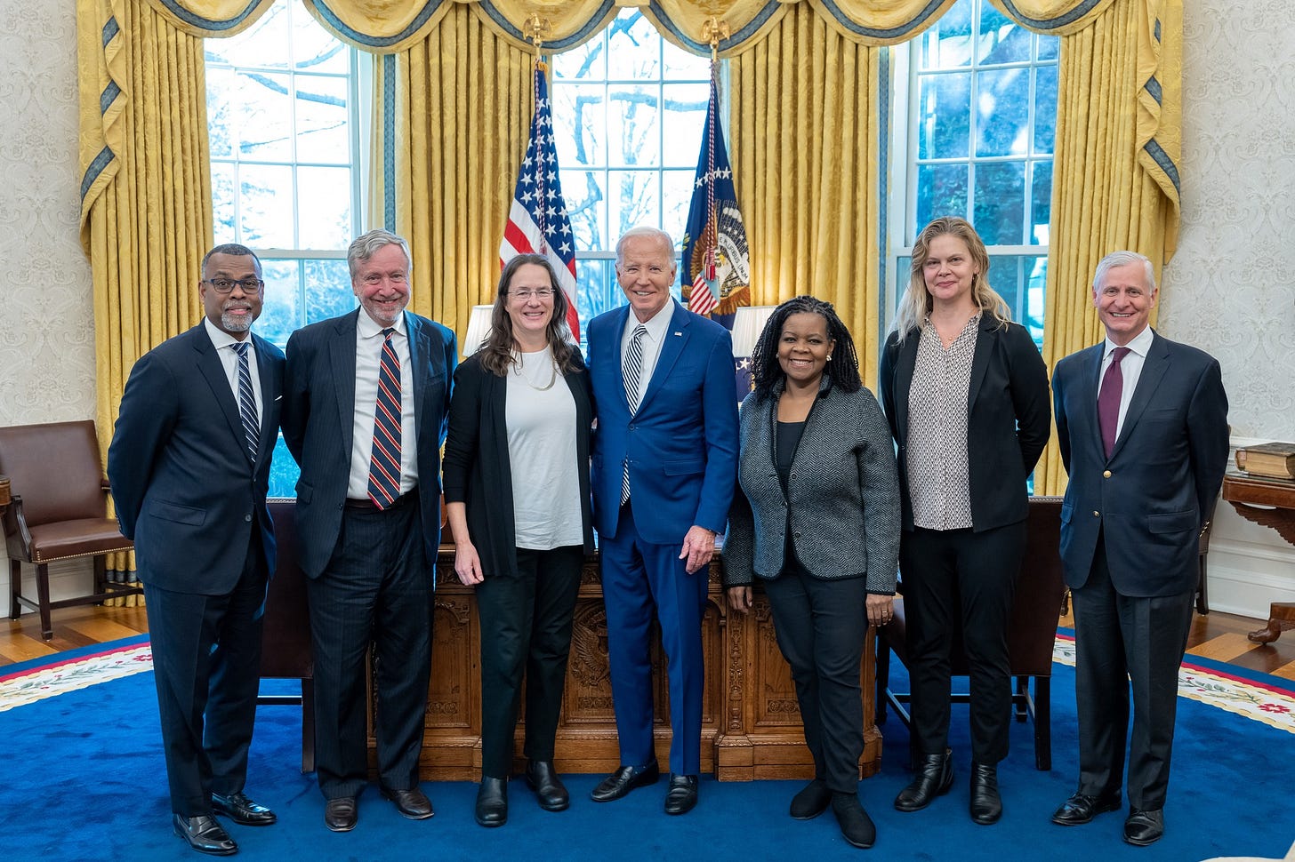 President Biden is pictured with a small group of scholars and historians in Oval Office.