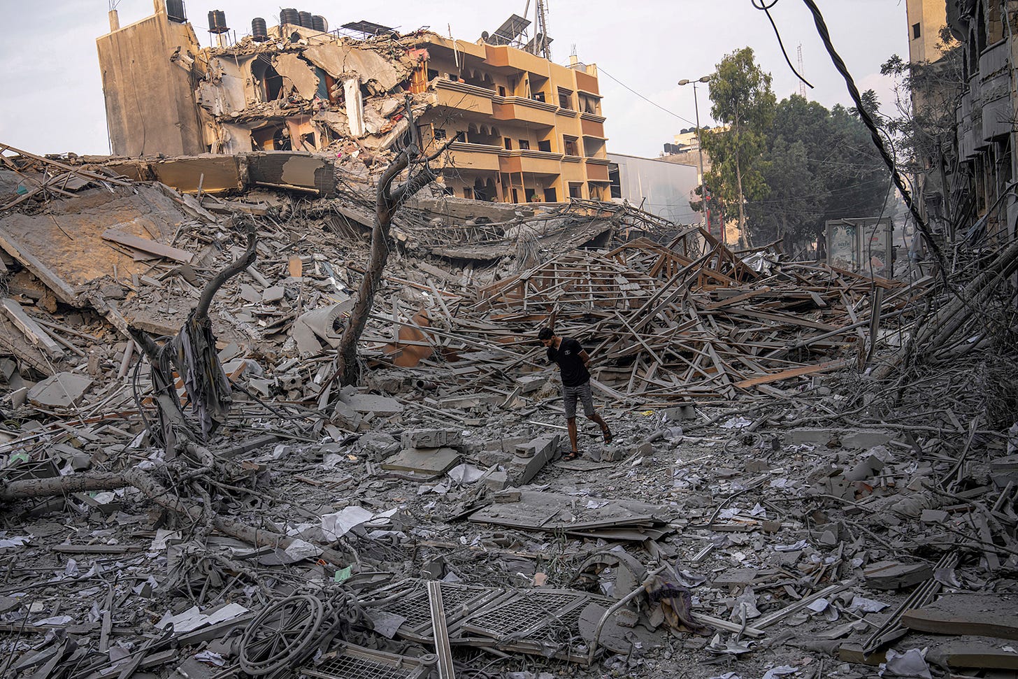 A man inspects the rubble of a building destroyed by an Israeli airstrike in Gaza City, on Sunday, October 8. 