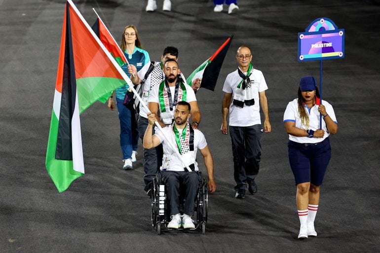 palesine athlete holds national flag.