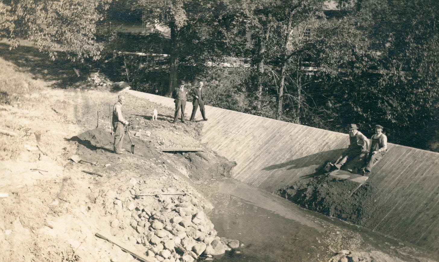 Workmen repairing dam