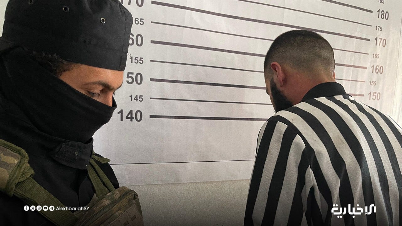 A person in a black mask looking at another person in a black and white striped shirt

AI-generated content may be incorrect.