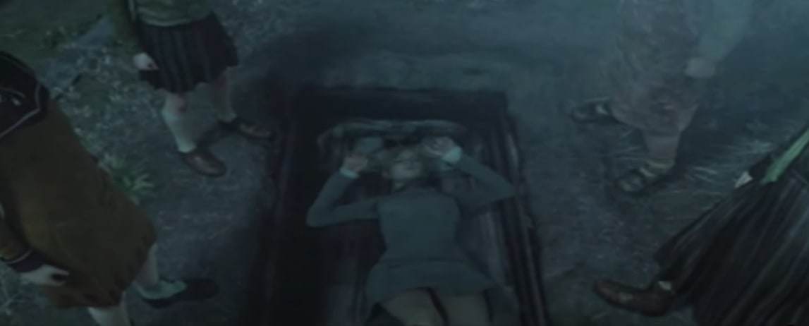 A screenshot from Rule of Rose where Jennifer has fallen dramatically into an open casket in a shallow grave. Looking down on her from either side are the members of the Aristocrat Club.