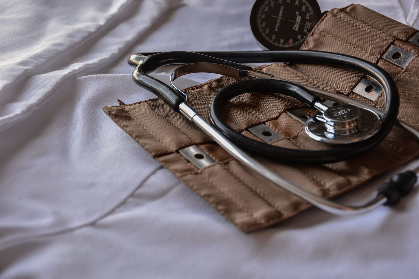 stethoscope and medical kit on hospital bed