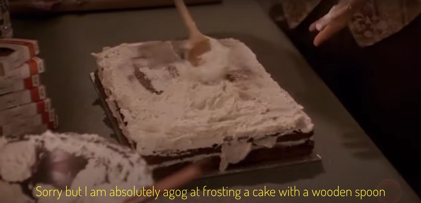An innocent sheet cake being frosted with a wooden spoon, captioned "Sorry but I am absolutely agog at frosting a cake with a wooden spoon." Is this a fetish thing? I do not know.