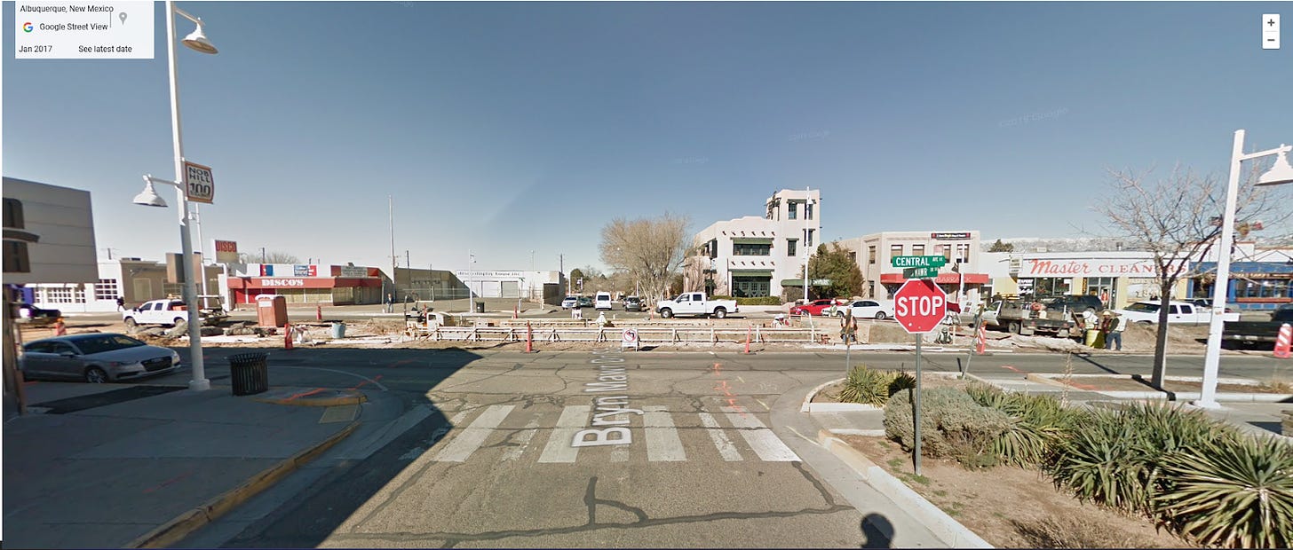 An intersection on Central Ave with the center of the street torn up for construction of an ART station.