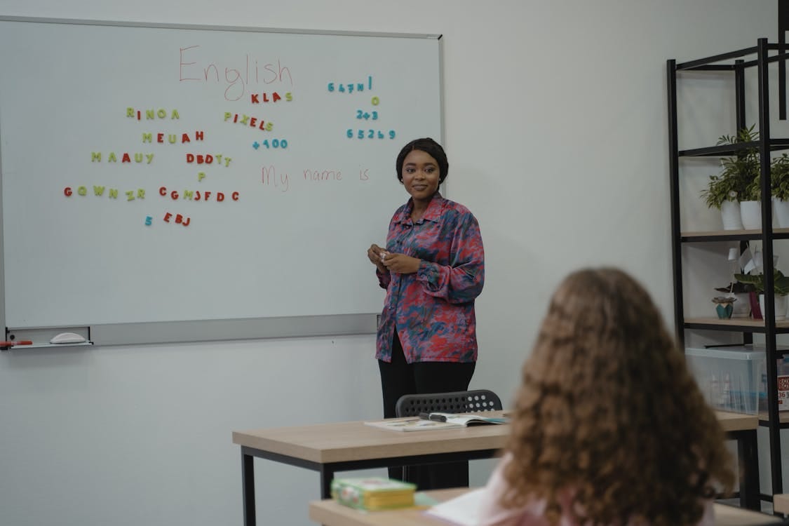 Free Woman Teaching English in Class Stock Photo