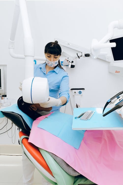 Free Female dentist working in modern office with patient Stock Photo