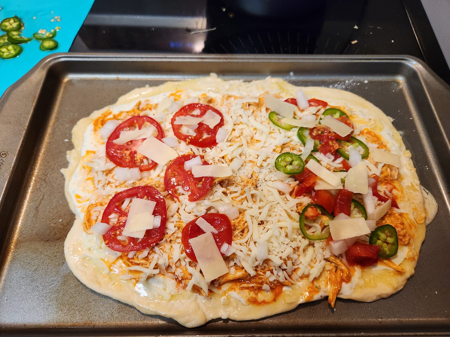 uncooked homemade pizza on a pan