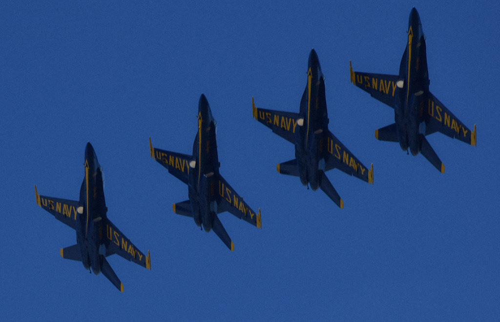 Four blue angel planes pointing upwards against a blue sky. "Blue Angels" by Leticia Roncero is licensed under CC BY-NC 2.0.