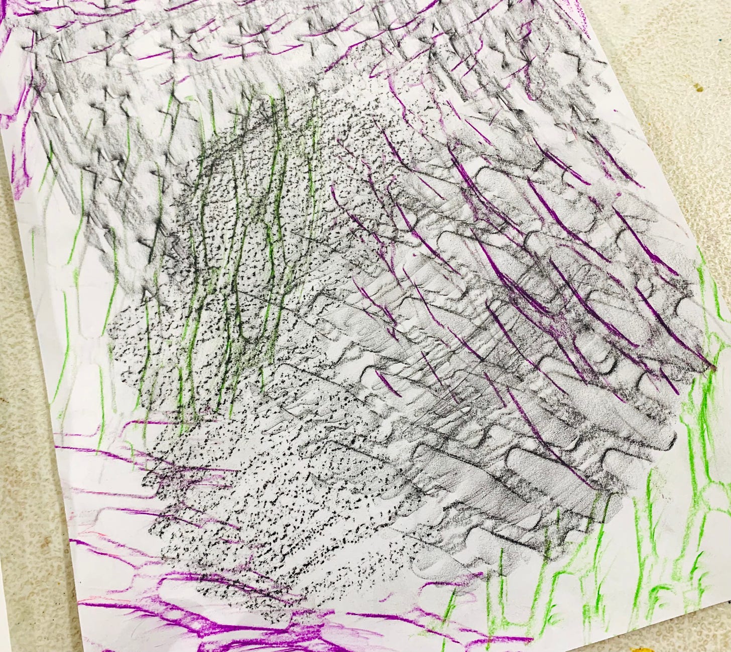 A white sheet of paper with rubbings of rectangular shapes in magenta, grey/black, and lime green.