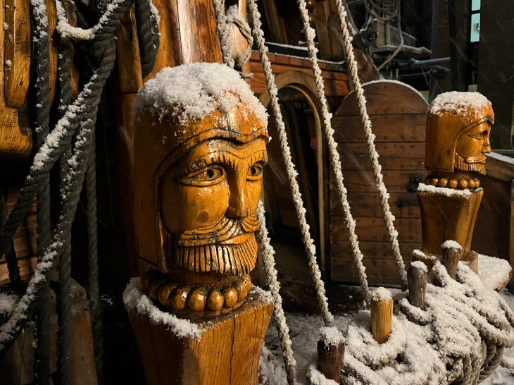 A wooden carving, part of the Golden Hinde ship, dusted with snow