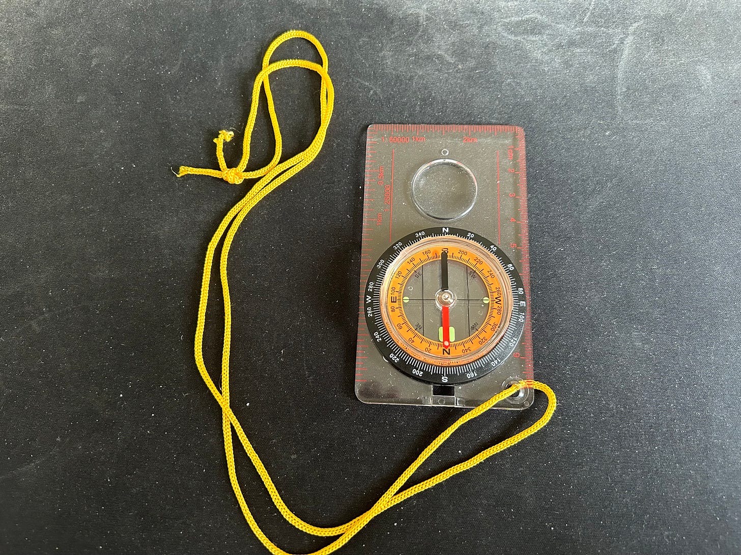 A baseplate magnetic compass used by hikers to get the correct directions from a map.