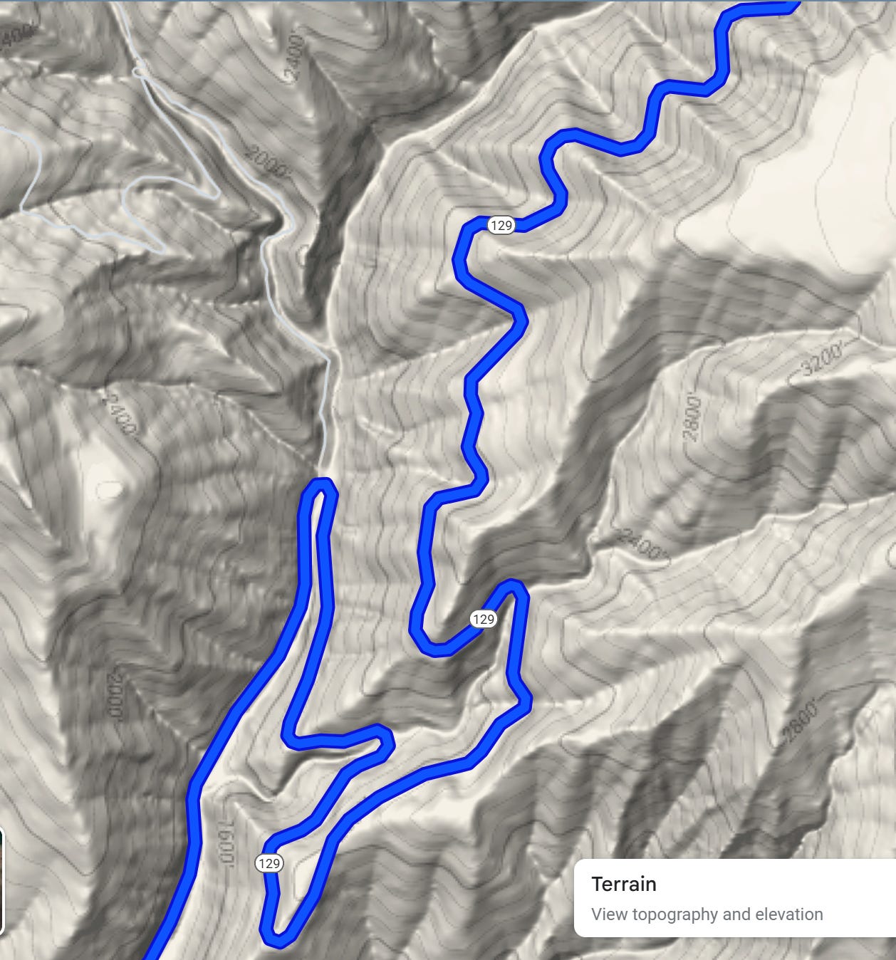 a Google Maps screenshot showing a blue ribbon of highway winding back and forth and up and over as it climbs out of a canyon