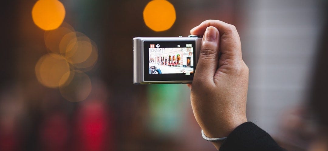 person holding digital camera