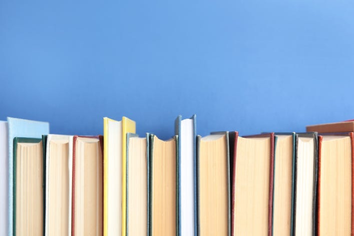 Ten books lined up against a wall