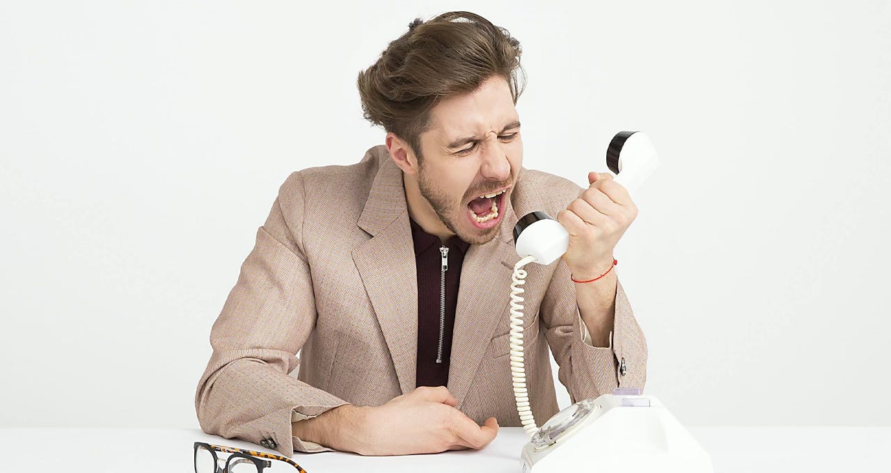 Man screams at a telephone