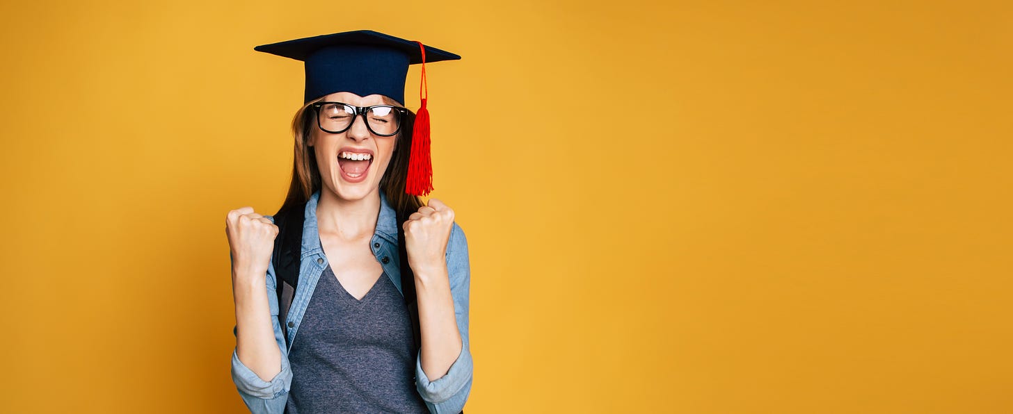 A young person in a graduation cap with a red tassel, making an excited gesture