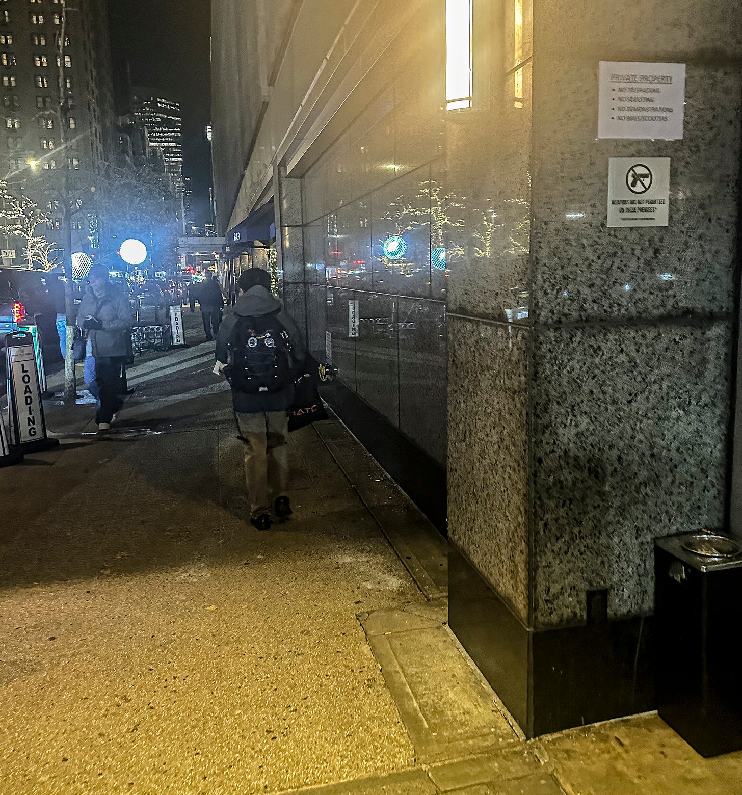 Smoker's corner outside the Hilton hotel entrance where UnitedHealthcare CEO Brian Thompson was killed.