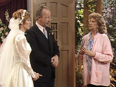 The Tanners attempt to explain their wedding getup to Mrs. Ochmonek during the Alf vow renewal.