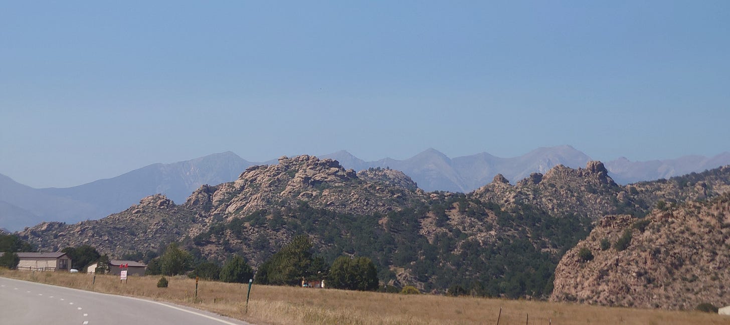 Road west of Pueblo, plateau, ridge and then mountains in the distance