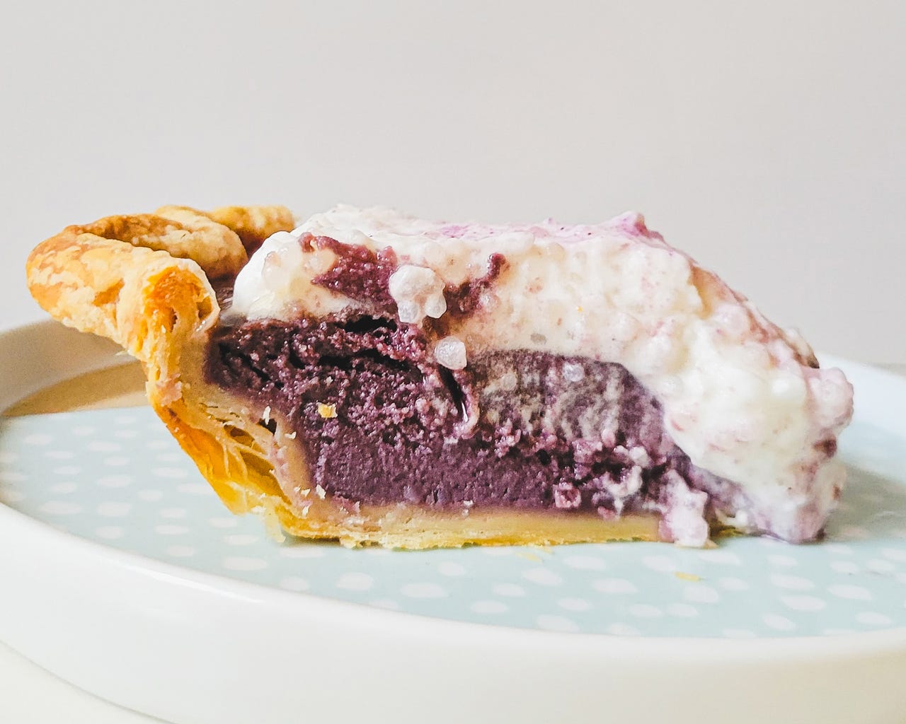 slice of purple and white pie on a plate