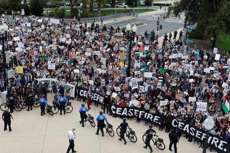 A crowd of demonstrators calling for a cease fire in Gaza and an end to the Israel-Hamas conflict are kept back by US Capitol police officers as other officers detain protestors holding a civil disobedience action inside the Cannon House office building on Capitol Hill in Washington, US, October 18, 2023